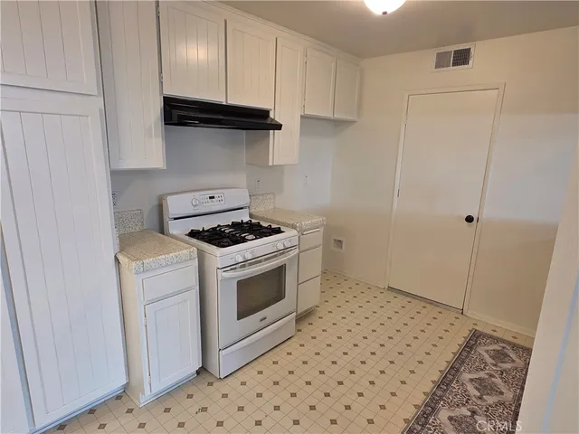 a bedroom with a bed and painting on the wall