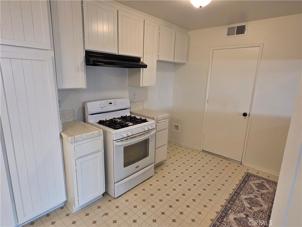 850 Vallejo Avenue Simi Valley, CA 93065 - Photo 7 of 50 a kitchen with a stove a sink and a refrigerator