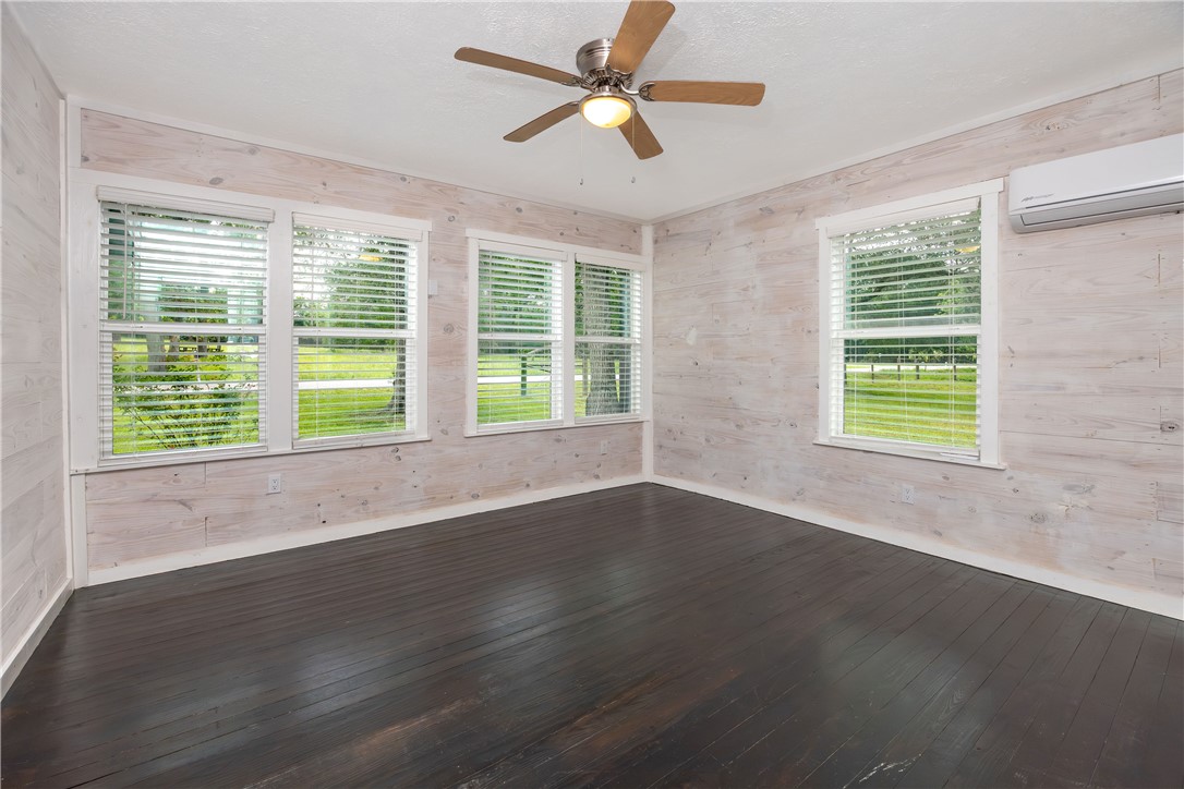 2283 Tigerpoint Road Brenham, TX 77833 - Photo 15 of 27 a view of an empty room with wooden floor and a window