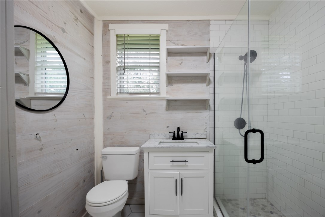2283 Tigerpoint Road Brenham, TX 77833 - Photo 17 of 27 a bathroom with a toilet sink and a window