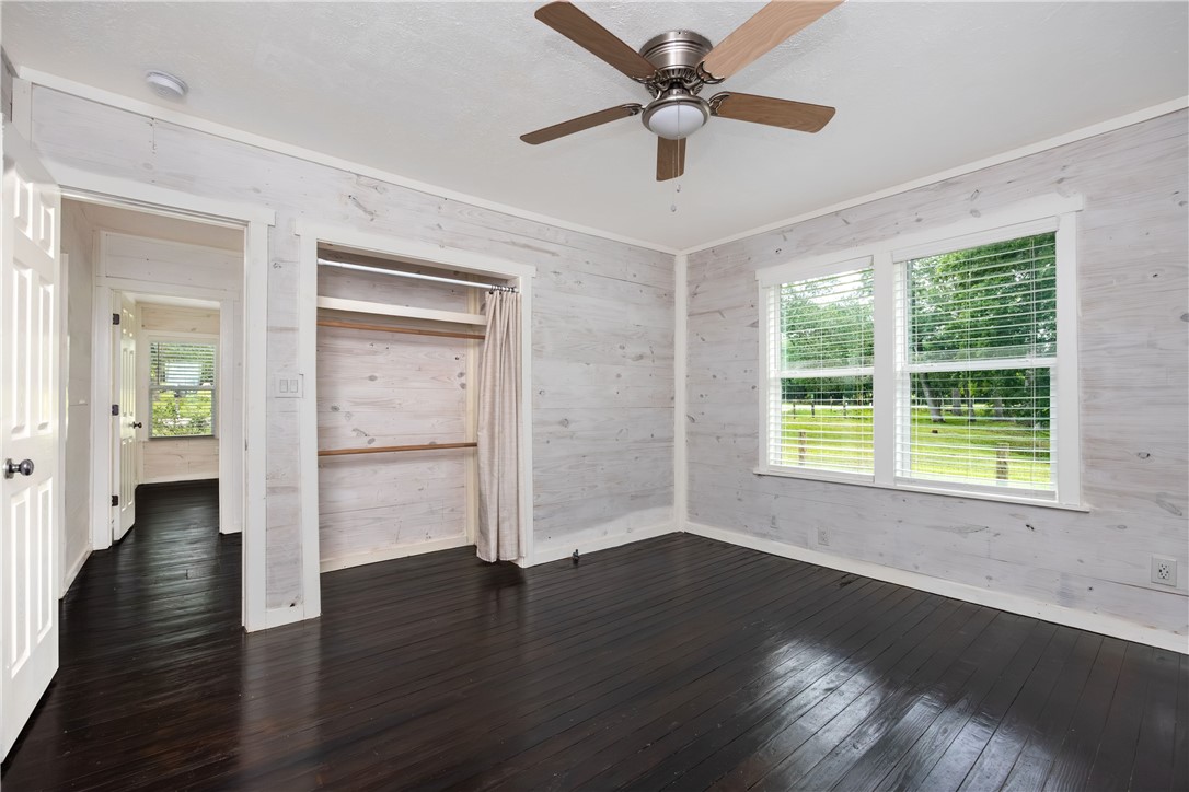 2283 Tigerpoint Road Brenham, TX 77833 - Photo 18 of 27 a view of an empty room with wooden floor and a window
