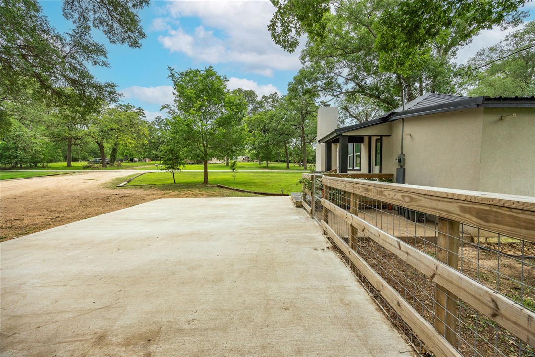 2283 Tigerpoint Road Brenham, TX 77833 - Photo 6 of 27 a view of a house with a yard and a large tree