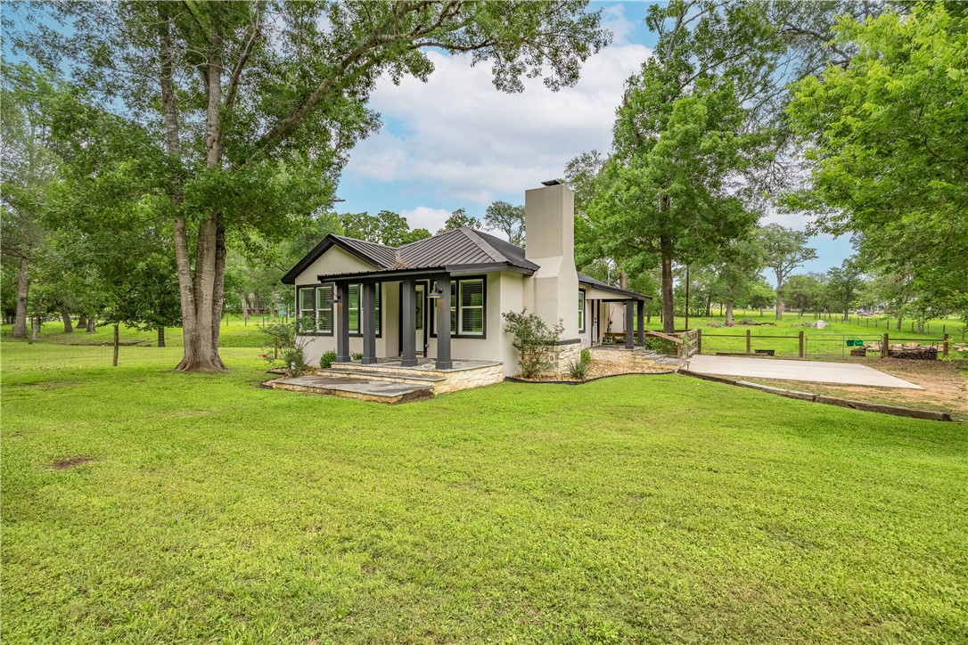 2283 Tigerpoint Road Brenham, TX 77833 - Photo 7 of 27 a front view of a house with swimming pool having outdoor seating