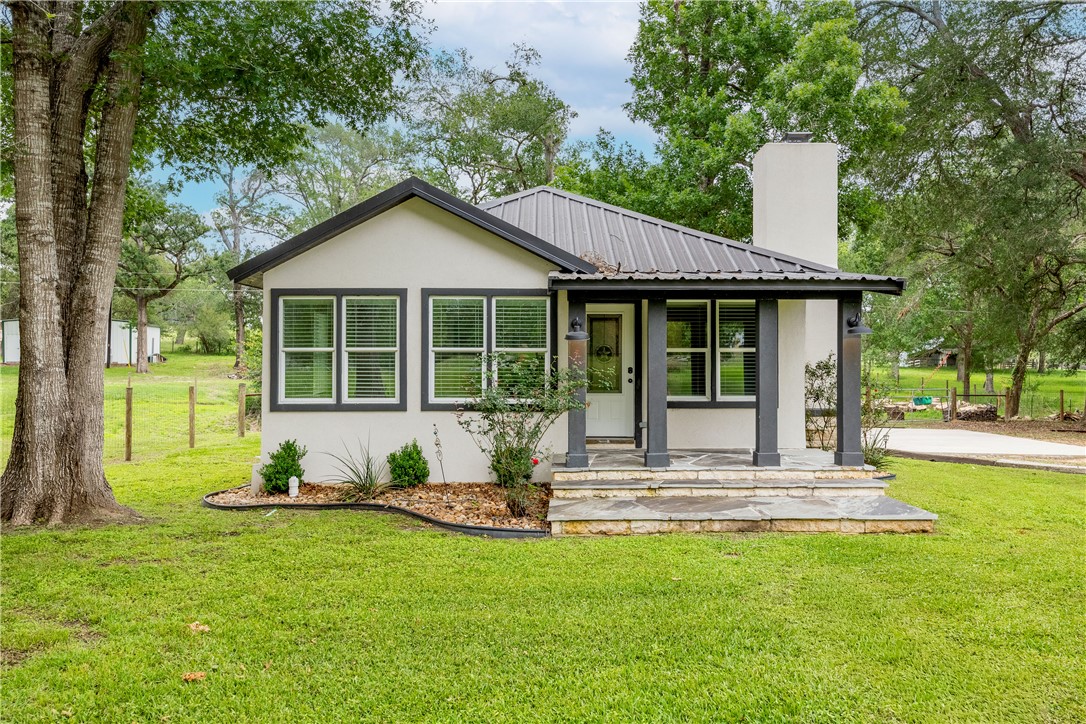 2283 Tigerpoint Road Brenham, TX 77833 - Photo 8 of 27 a house with trees in the background