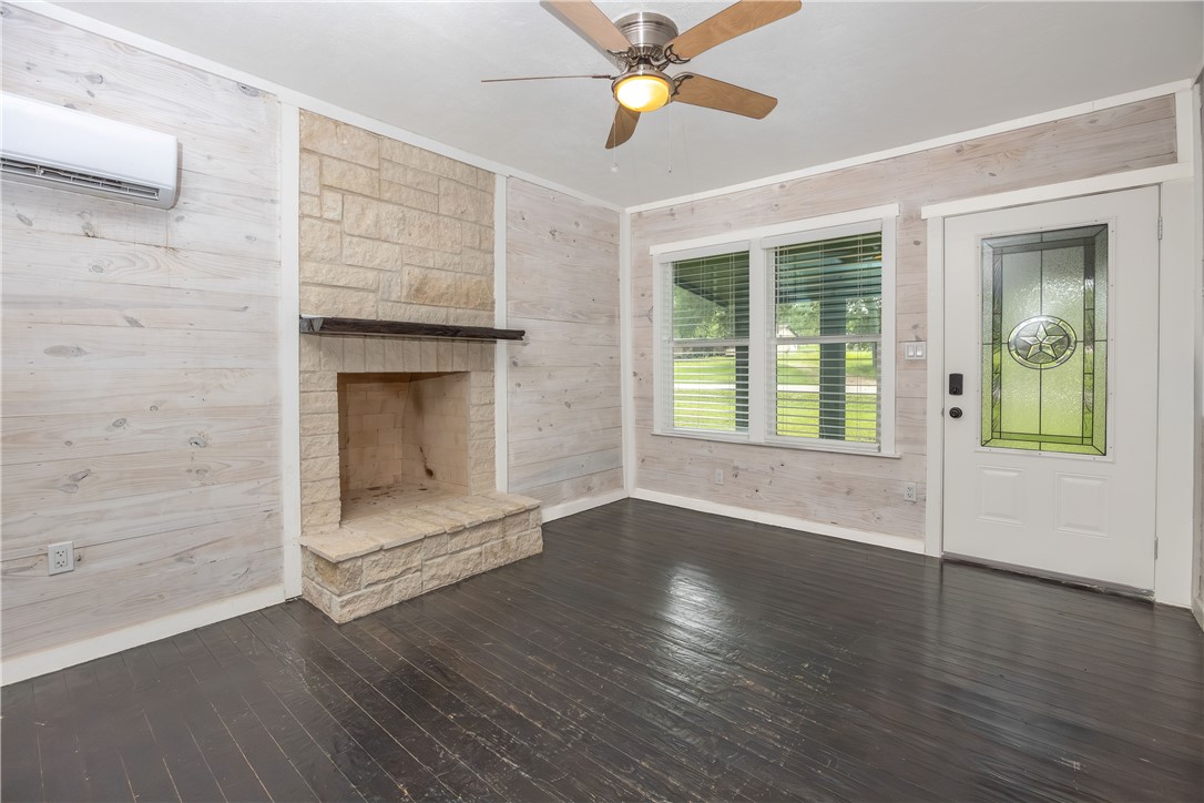 2283 Tigerpoint Road Brenham, TX 77833 - Photo 9 of 27 a view of an empty room with wooden floor and a window