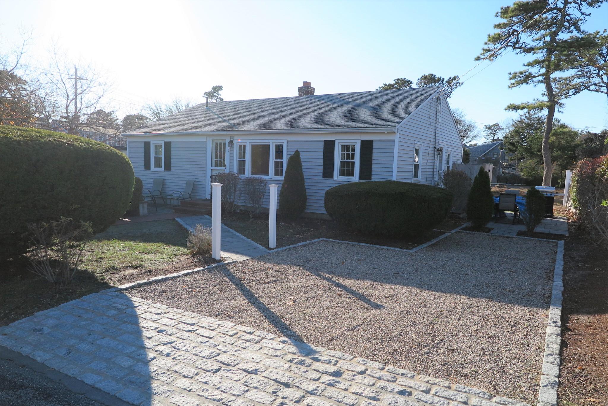 1 Hamilton Road Dennis Port, MA 02639 - Photo 24 of 29 a front view of a house with a yard