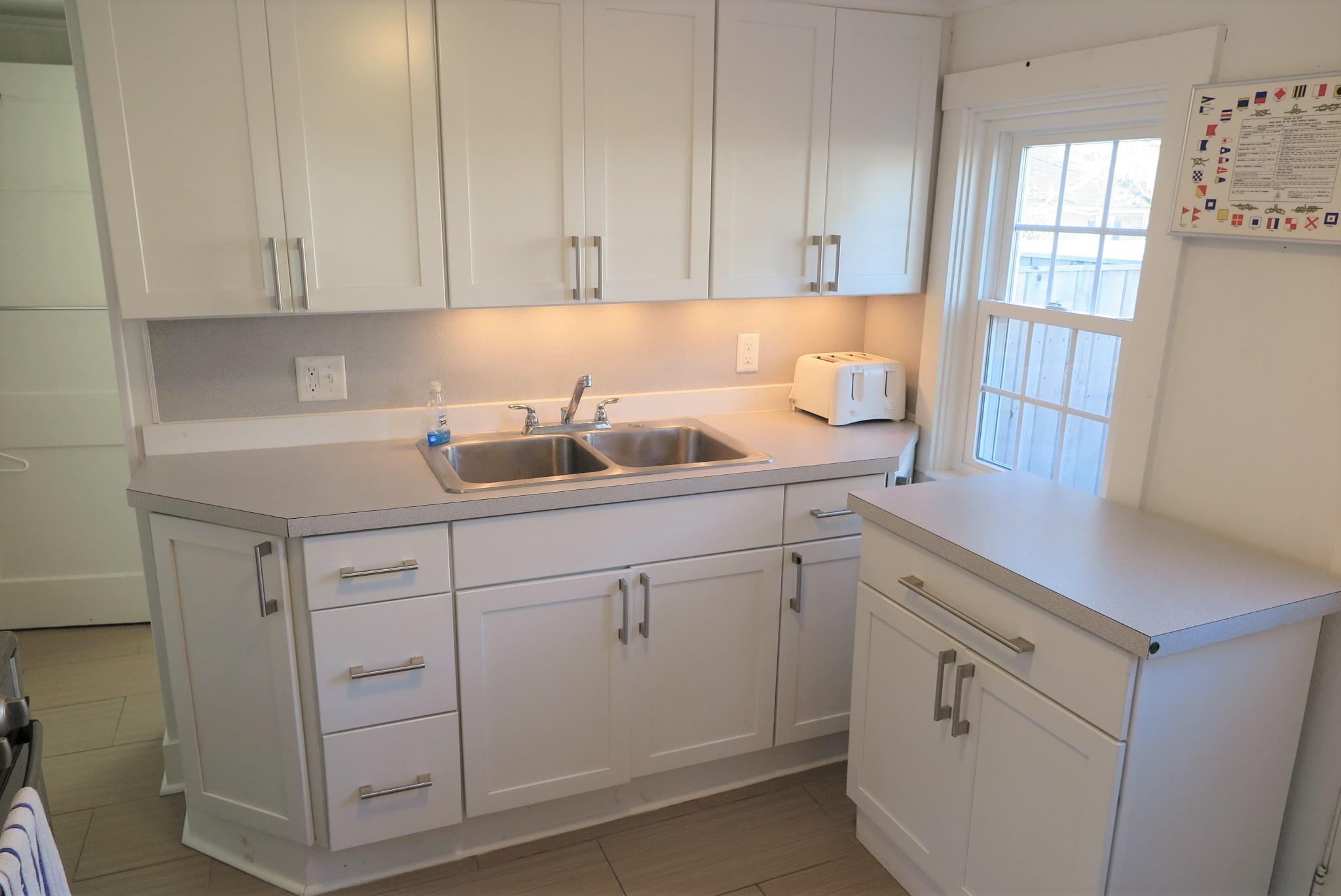 1 Hamilton Road Dennis Port, MA 02639 - Photo 10 of 29 a kitchen with white cabinets and white appliances