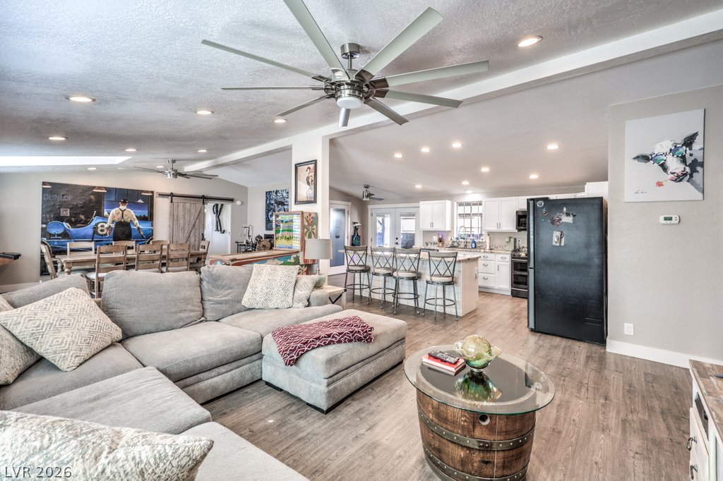 4375 Pinwheel Street Logandale, NV 89021 - Photo 12 of 52 An inviting open-concept area combines living and dining with a full kitchen, ideal for effortless entertaining.