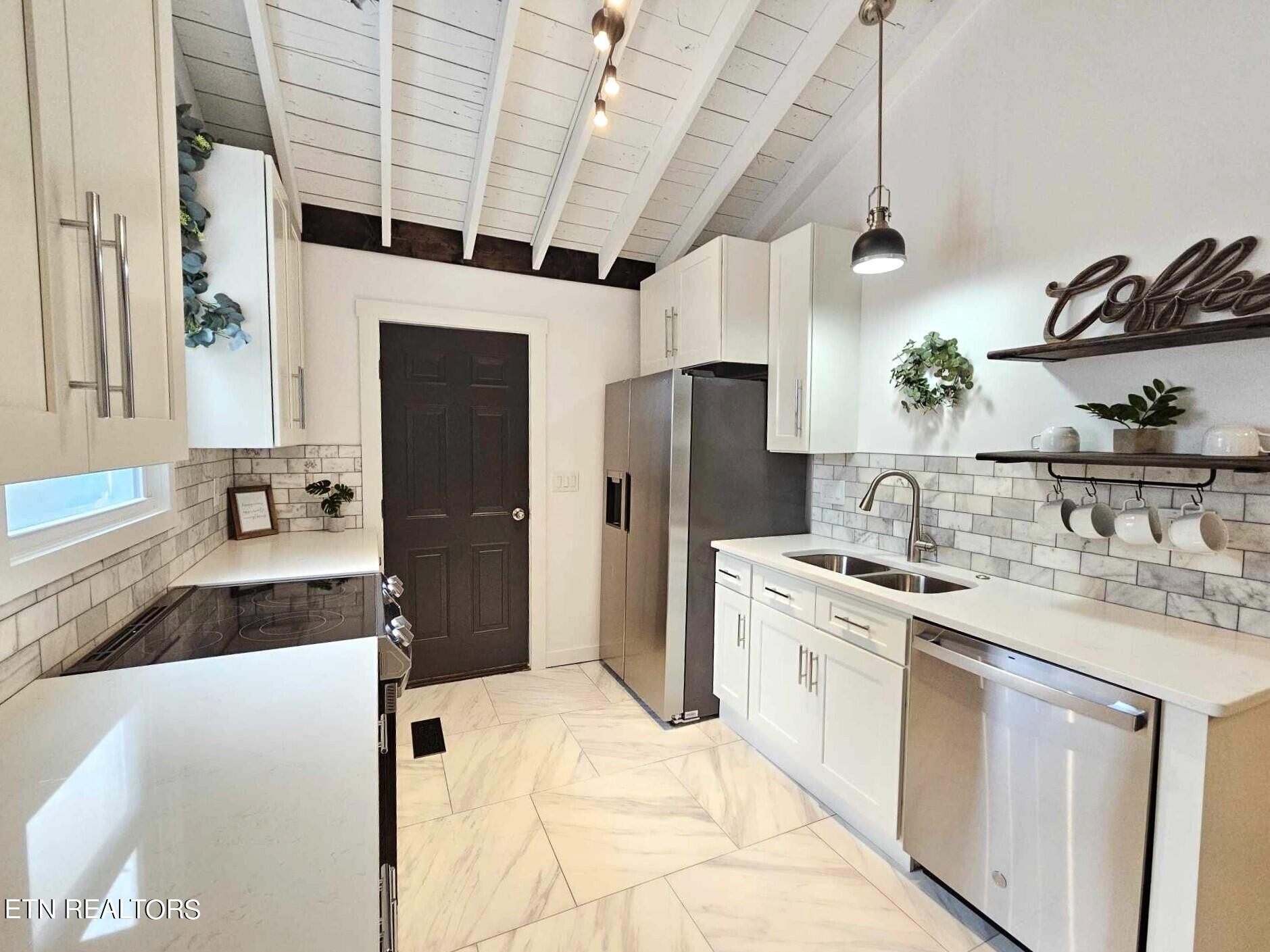 136 Main Road Maryville, TN 37804 - Photo 8 of 24 a kitchen with stainless steel appliances granite countertop a sink stove and refrigerator
