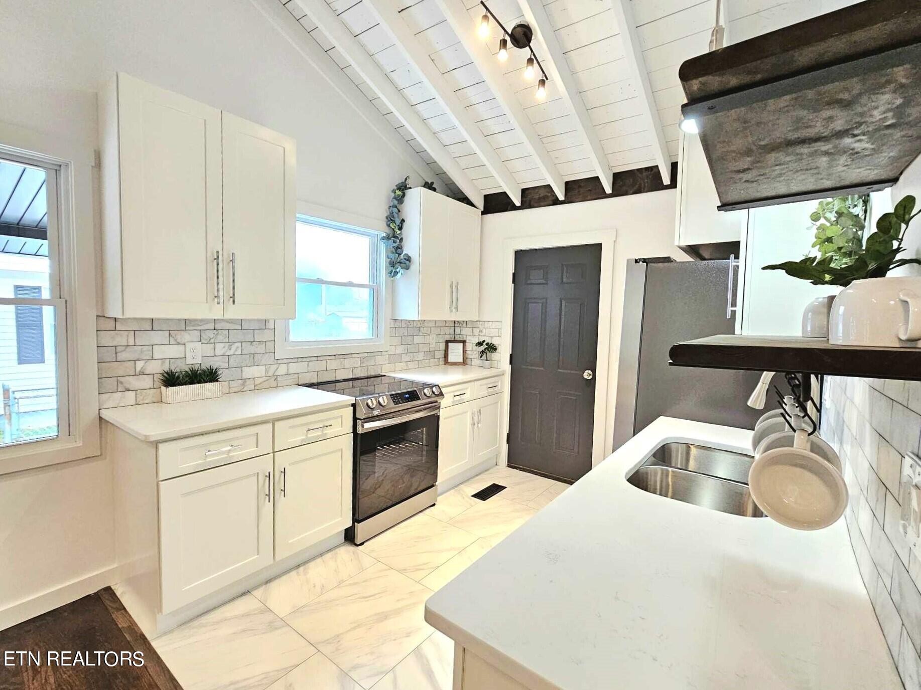 136 Main Road Maryville, TN 37804 - Photo 10 of 24 a kitchen with a sink a stove and refrigerator