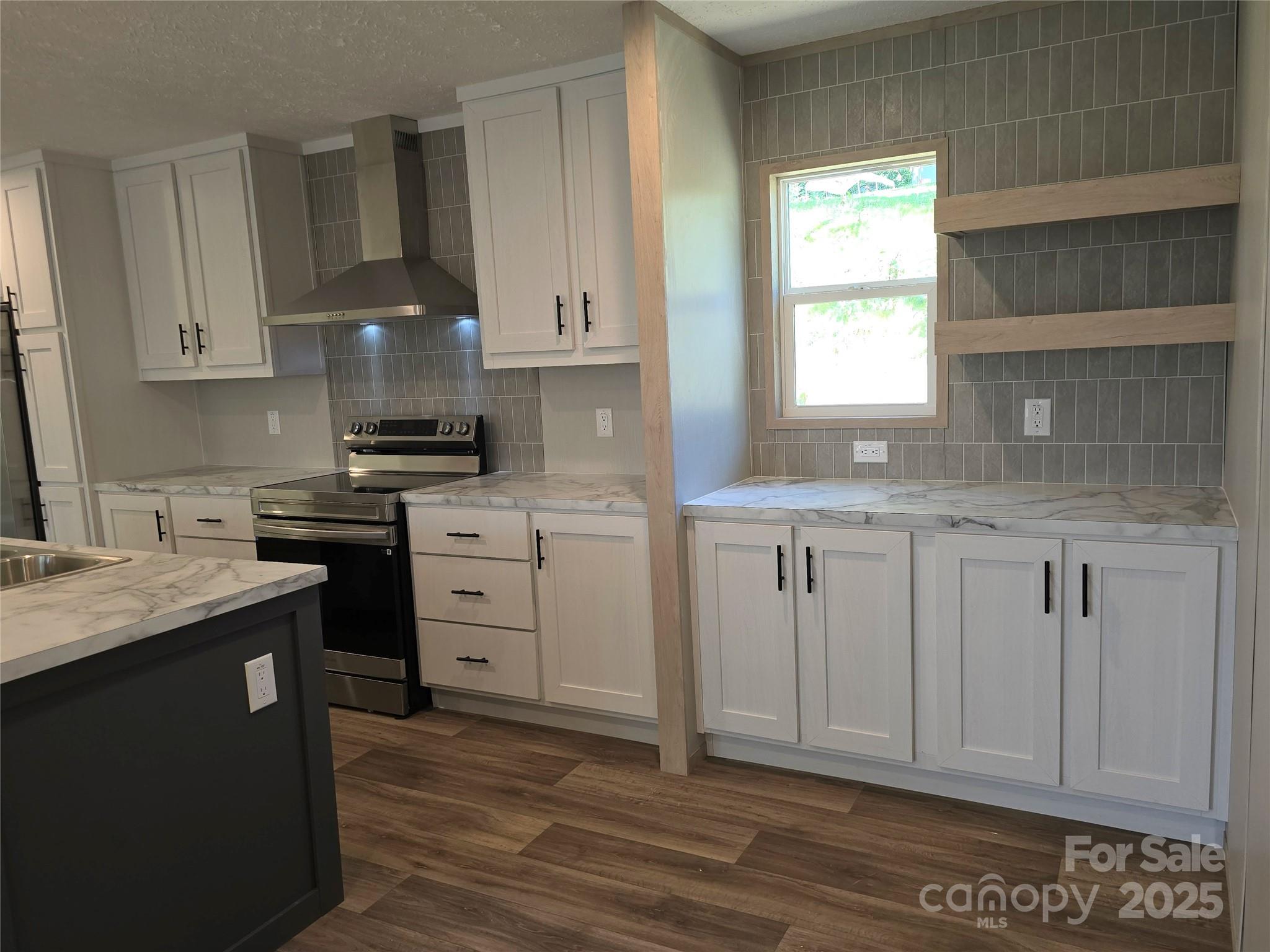 12 McGee Hl Road Fairview, NC 28730 - Photo 11 of 25 a kitchen with white cabinets appliances a sink and a window