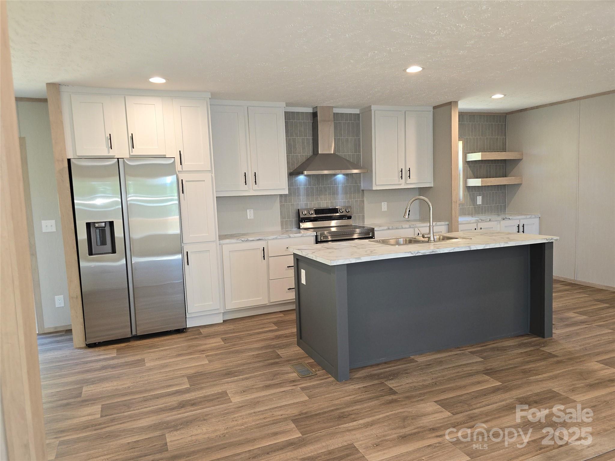12 McGee Hl Road Fairview, NC 28730 - Photo 13 of 25 a kitchen with kitchen island a counter top space cabinets and stainless steel appliances
