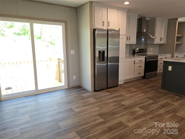 a kitchen with stainless steel appliances a refrigerator sink and cabinets