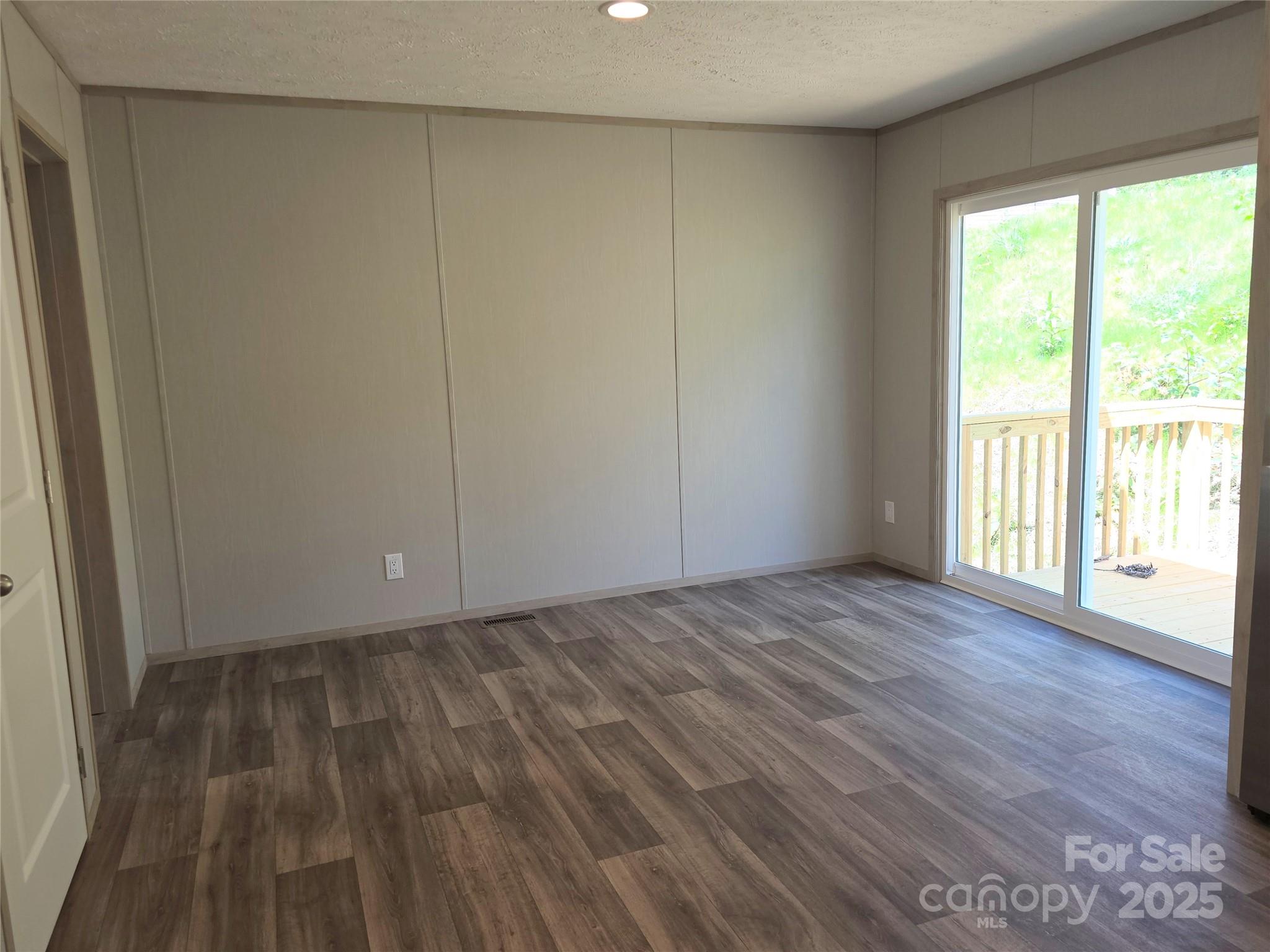 12 McGee Hl Road Fairview, NC 28730 - Photo 15 of 25 a view of an empty room with wooden floor and a window