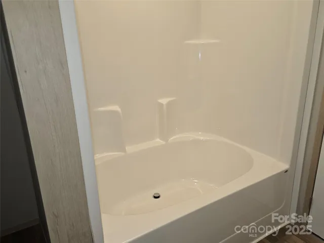 a white bath tub sitting in a bathroom