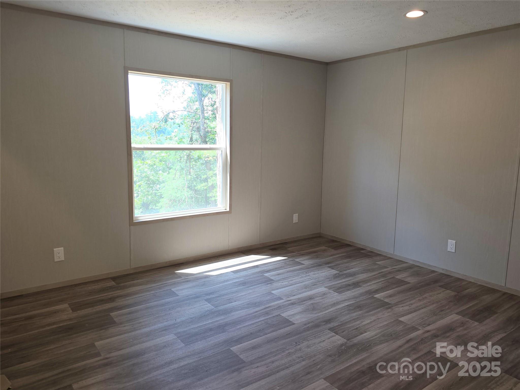 12 McGee Hl Road Fairview, NC 28730 - Photo 19 of 25 an empty room with wooden floor and windows