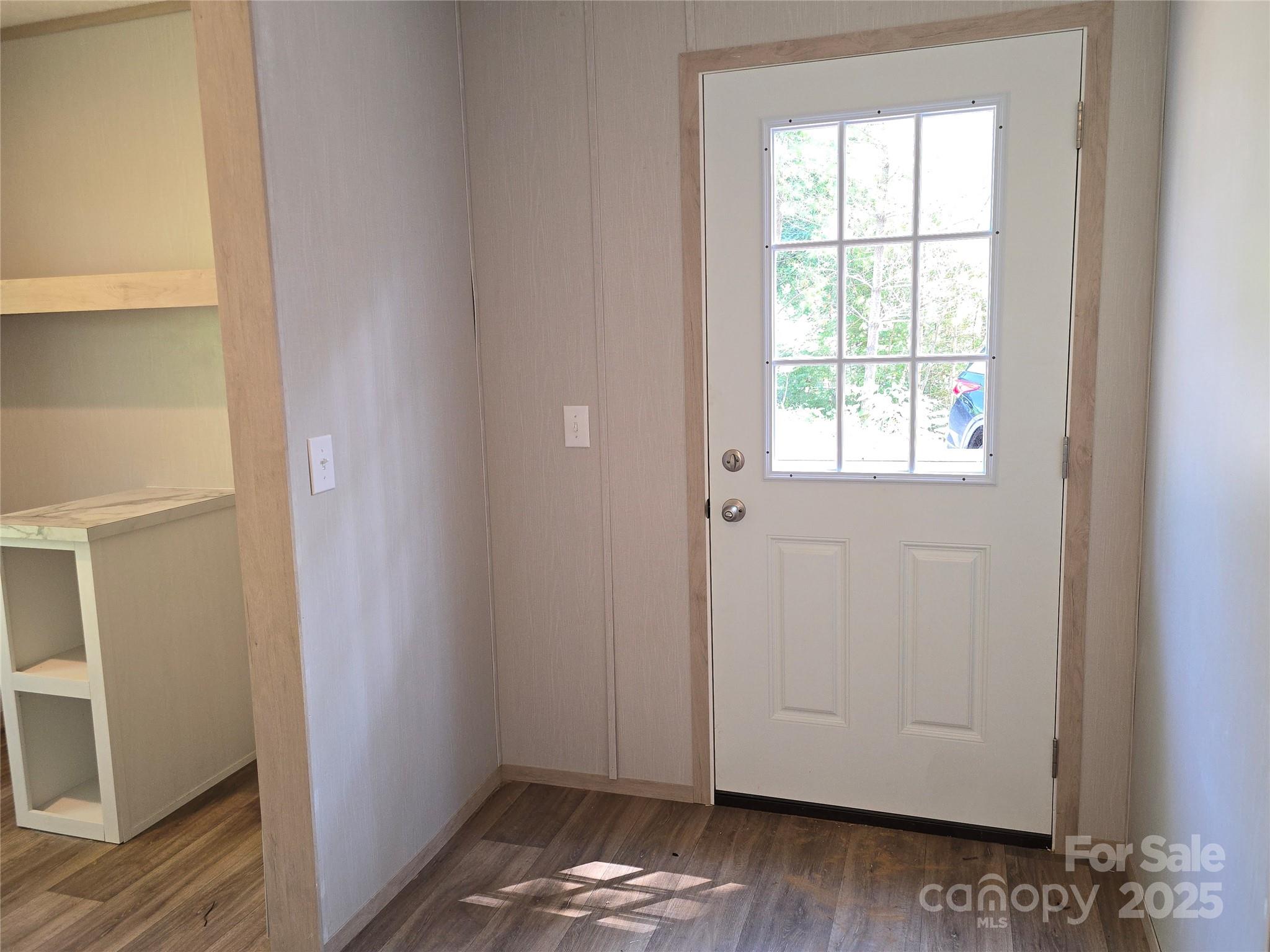 12 McGee Hl Road Fairview, NC 28730 - Photo 21 of 25 an empty room with wooden floor and windows