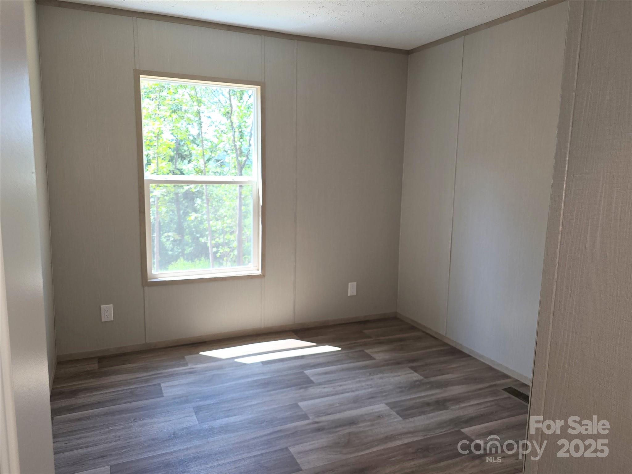 12 McGee Hl Road Fairview, NC 28730 - Photo 23 of 25 an empty room with wooden floor and windows