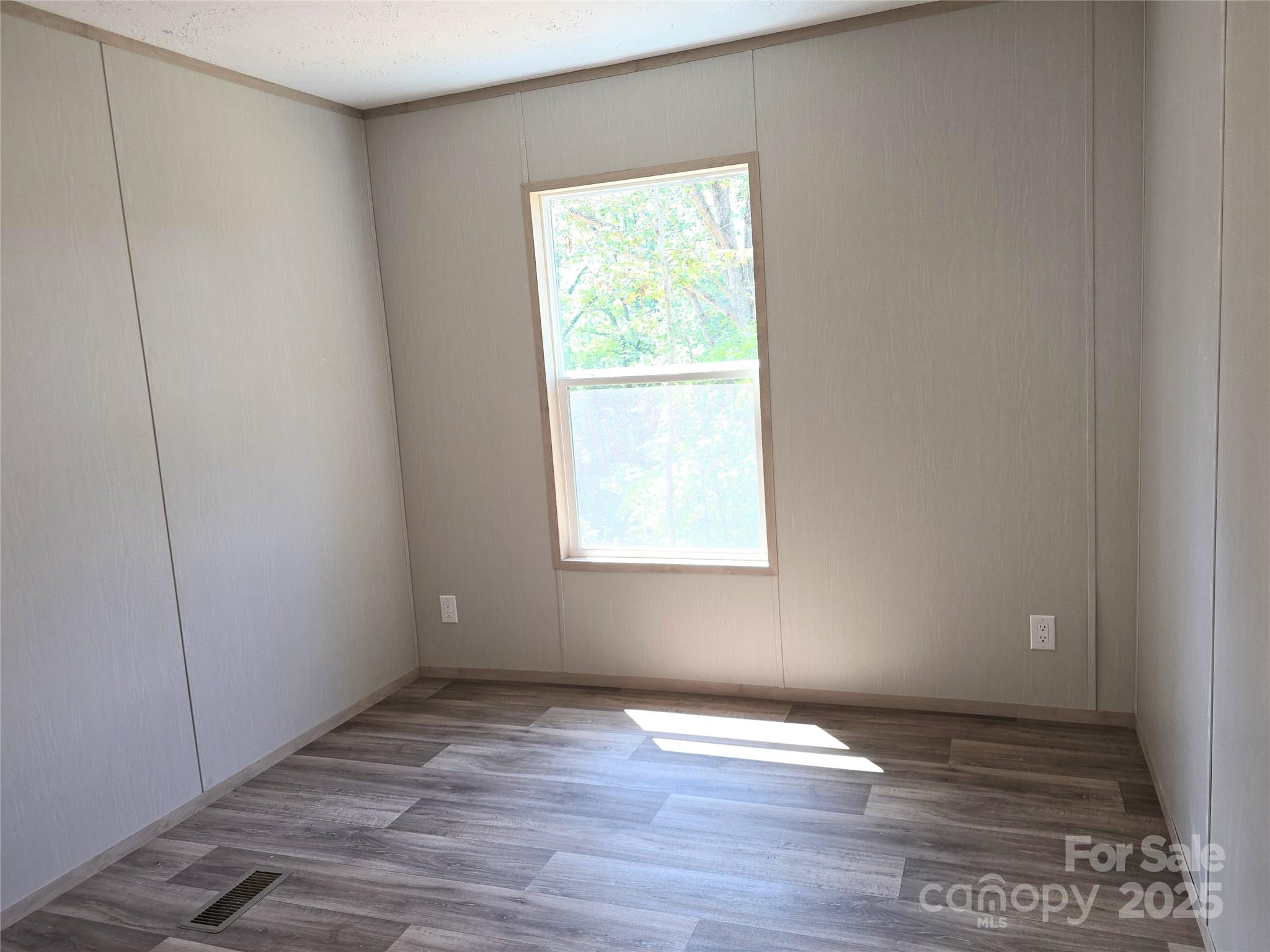 12 McGee Hl Road Fairview, NC 28730 - Photo 24 of 25 a view of an empty room with wooden floor and a window