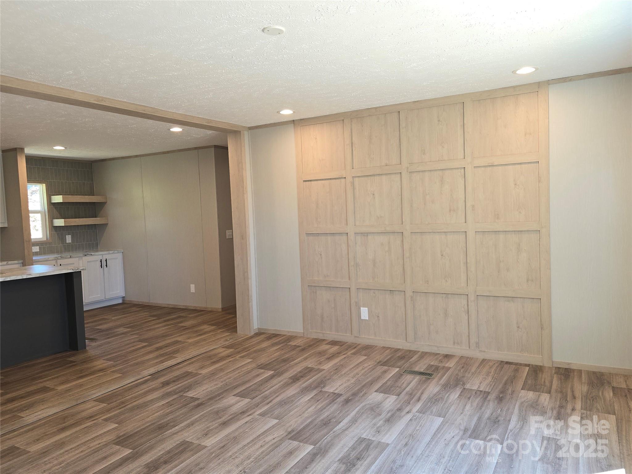 12 McGee Hl Road Fairview, NC 28730 - Photo 4 of 25 wooden floor in an empty room with a kitchen