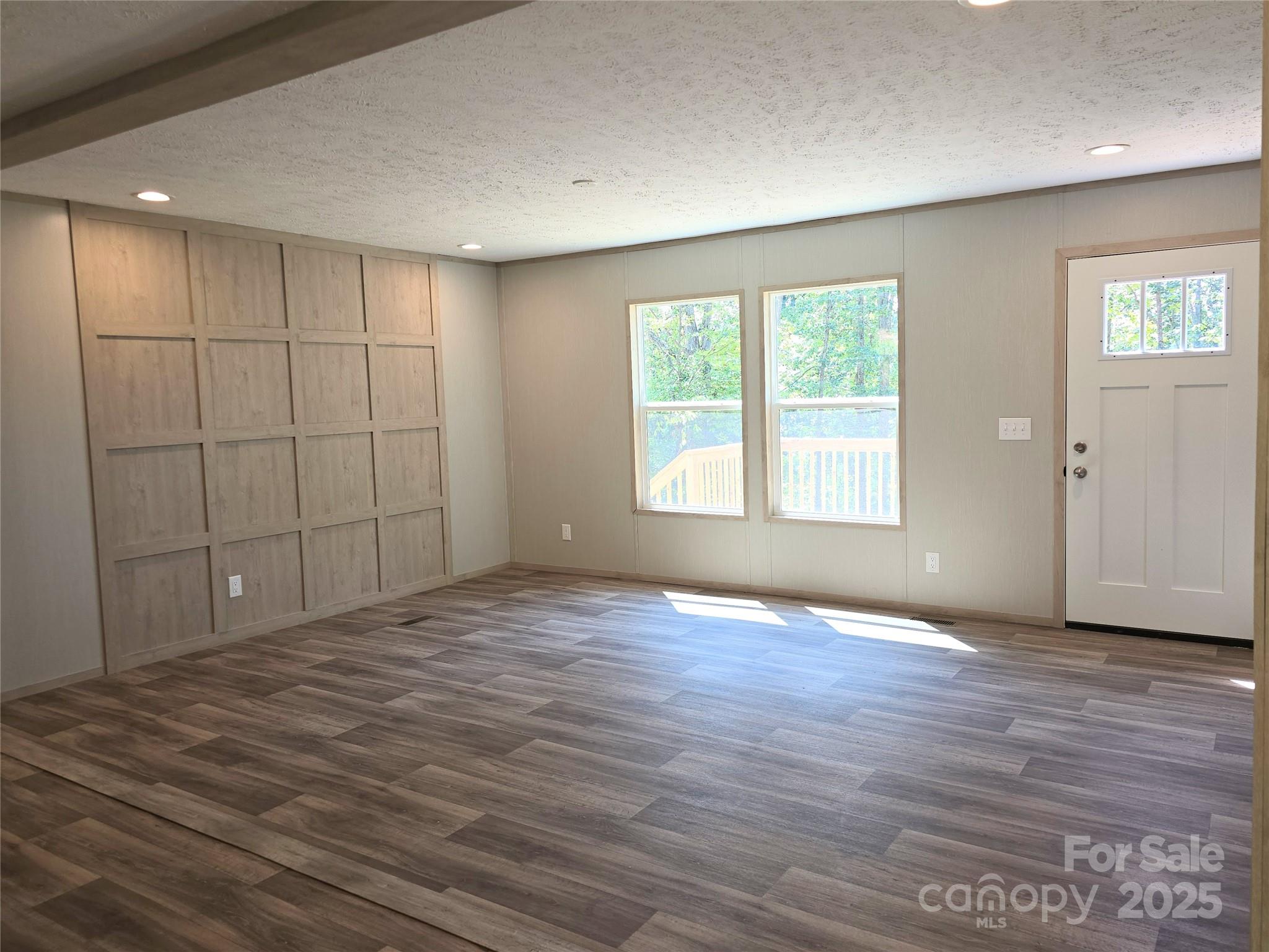 12 McGee Hl Road Fairview, NC 28730 - Photo 5 of 25 a view of an empty room with wooden floor and a window