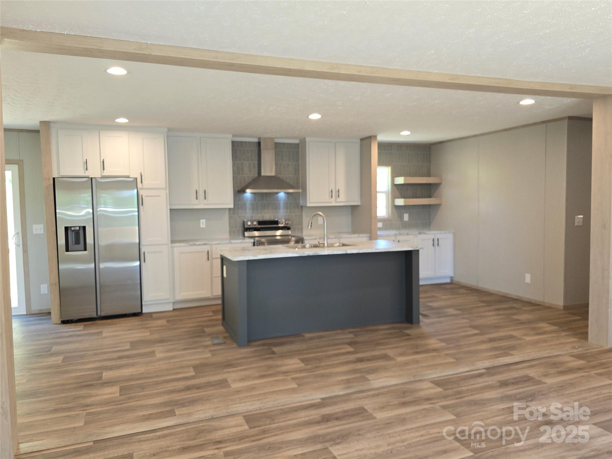 12 McGee Hl Road Fairview, NC 28730 - Photo 7 of 25 a kitchen with kitchen island stainless steel appliances a refrigerator sink and cabinets