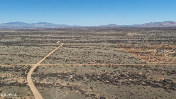 a view of an ocean beach and mountain