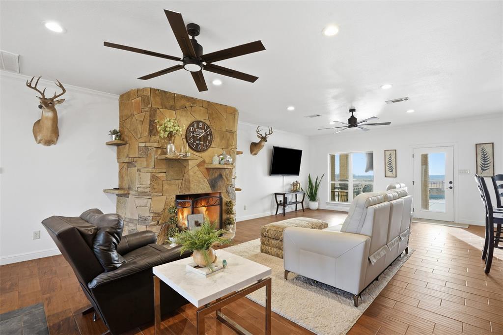 2701 County Road 1110 Rio Vista, TX 76093 - Photo 11 of 39 a living room with furniture a rug and a flat screen tv