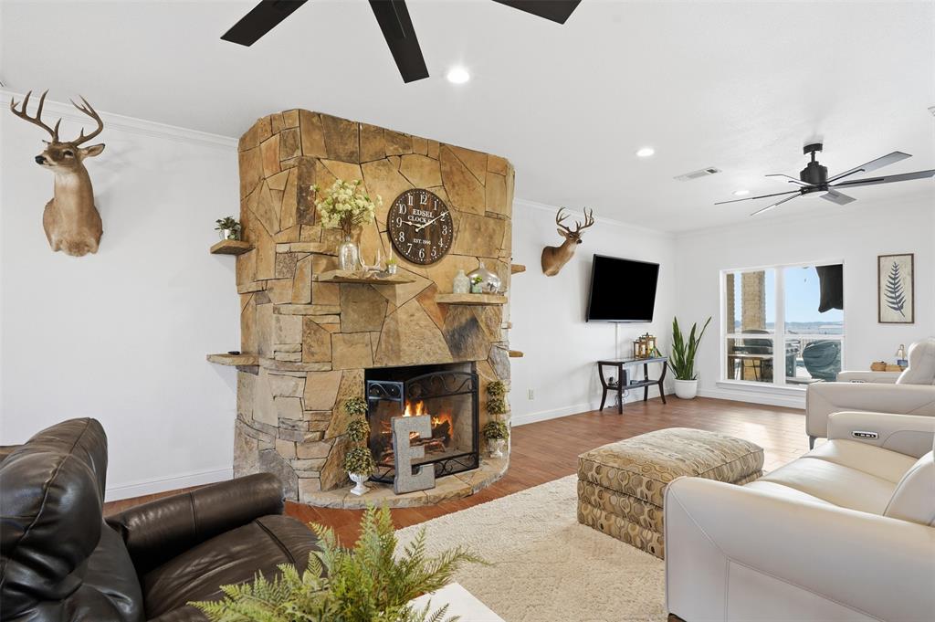 2701 County Road 1110 Rio Vista, TX 76093 - Photo 12 of 39 a living room with furniture and a fireplace