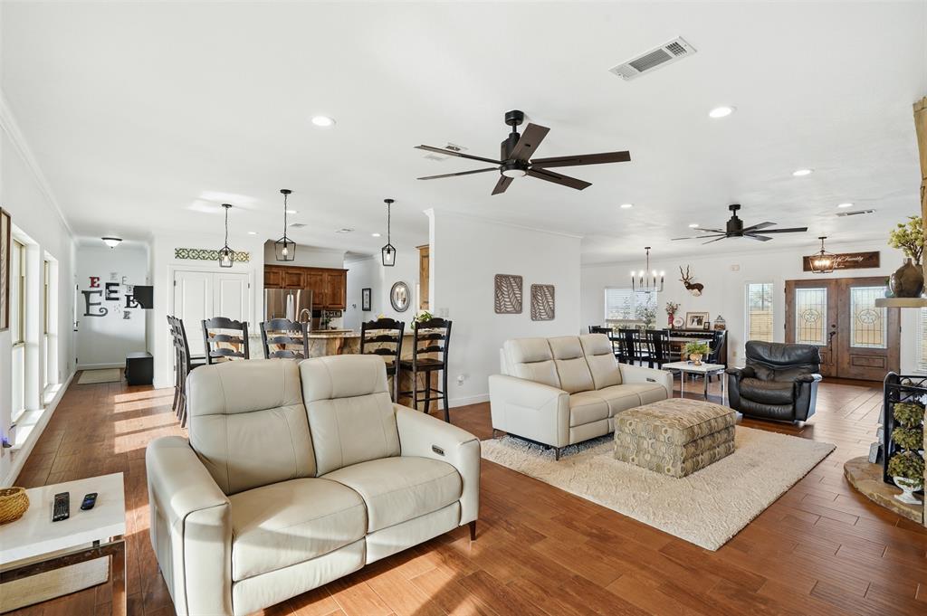 2701 County Road 1110 Rio Vista, TX 76093 - Photo 14 of 39 a living room with furniture kitchen view and a chandelier