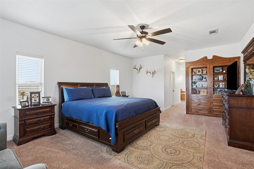 2701 County Road 1110 Rio Vista, TX 76093 - Photo 20 of 39 a spacious bedroom with a bed and dresser