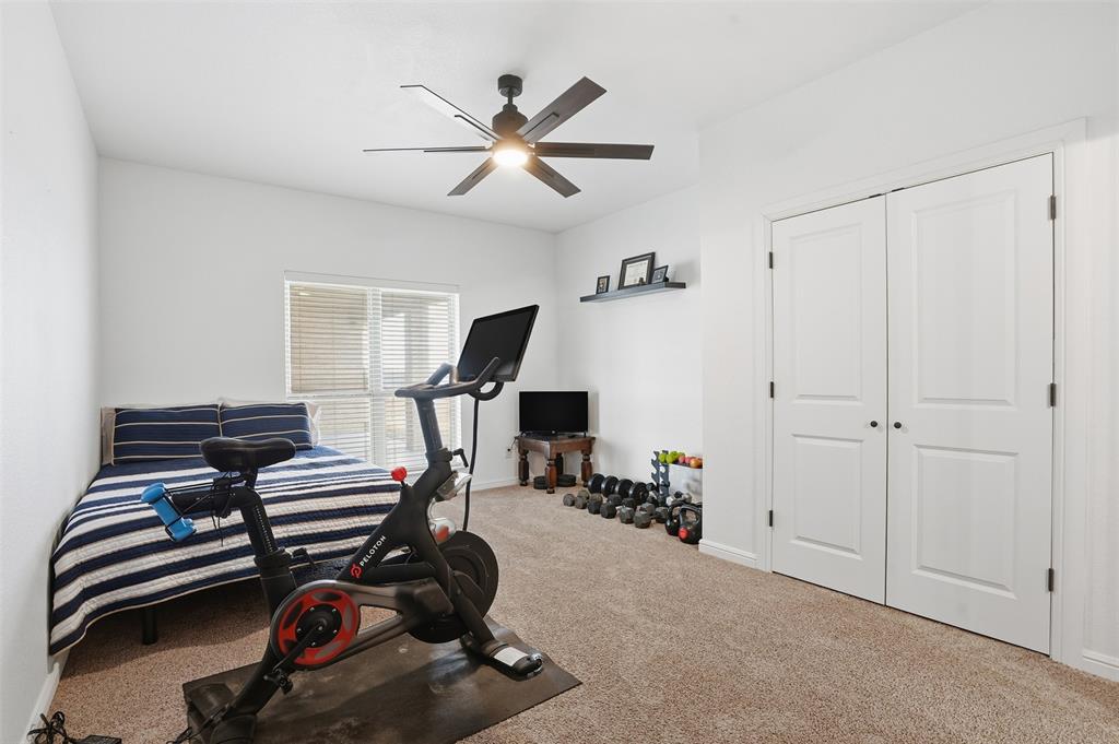 2701 County Road 1110 Rio Vista, TX 76093 - Photo 28 of 39 a room with gym equipment and windows