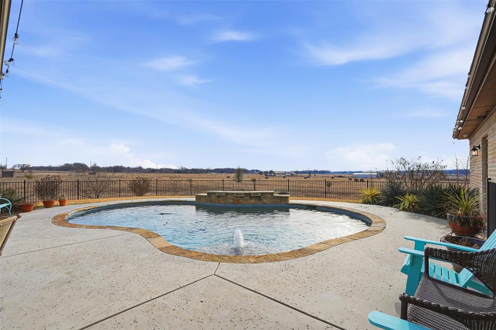2701 County Road 1110 Rio Vista, TX 76093 - Photo 35 of 39 a view of a swimming pool with a lounge chair
