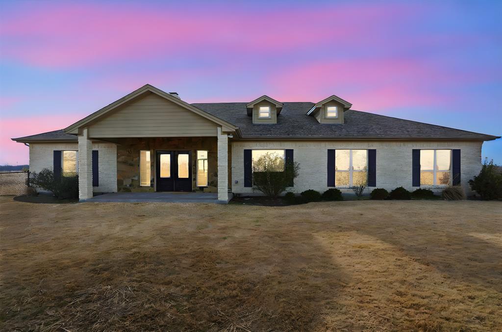 2701 County Road 1110 Rio Vista, TX 76093 - Photo 5 of 39 a front view of a house with a garden
