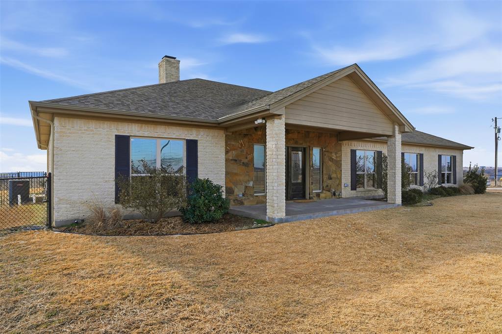 2701 County Road 1110 Rio Vista, TX 76093 - Photo 6 of 39 a front view of a house with garden