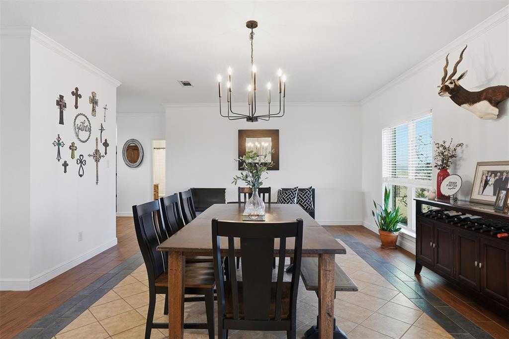 2701 County Road 1110 Rio Vista, TX 76093 - Photo 9 of 39 a dining room with furniture a chandelier and wooden floor