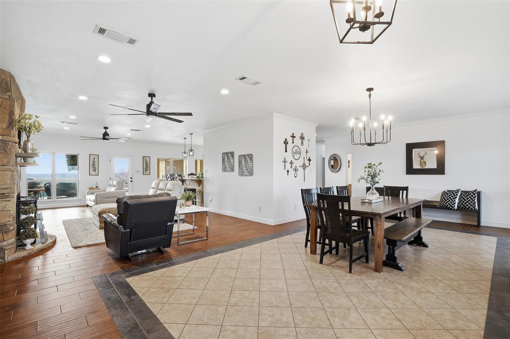 2701 County Road 1110 Rio Vista, TX 76093 - Photo 10 of 39 a view of a dining room with furniture and chandelier