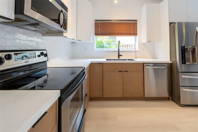 a kitchen with a stove and a refrigerator