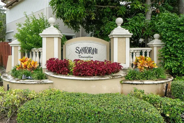 a front view of a house with a yard and fountain