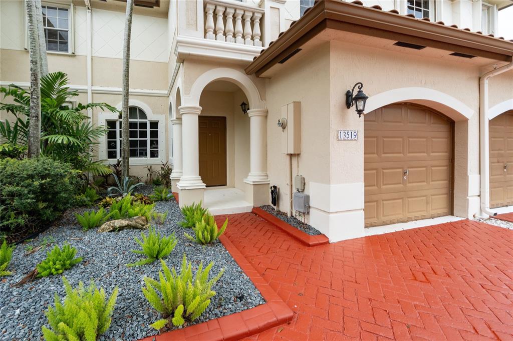 13519 Southwest 50th Court Miramar, FL 33027 - Photo 3 of 26 a front view of a house with a yard