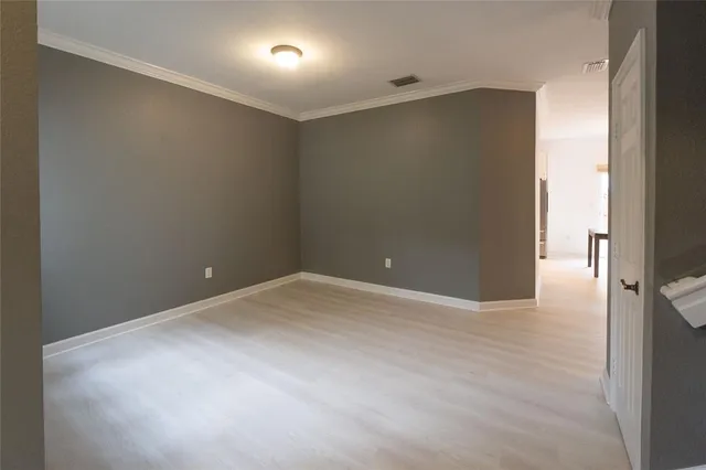 an empty room with wooden floor