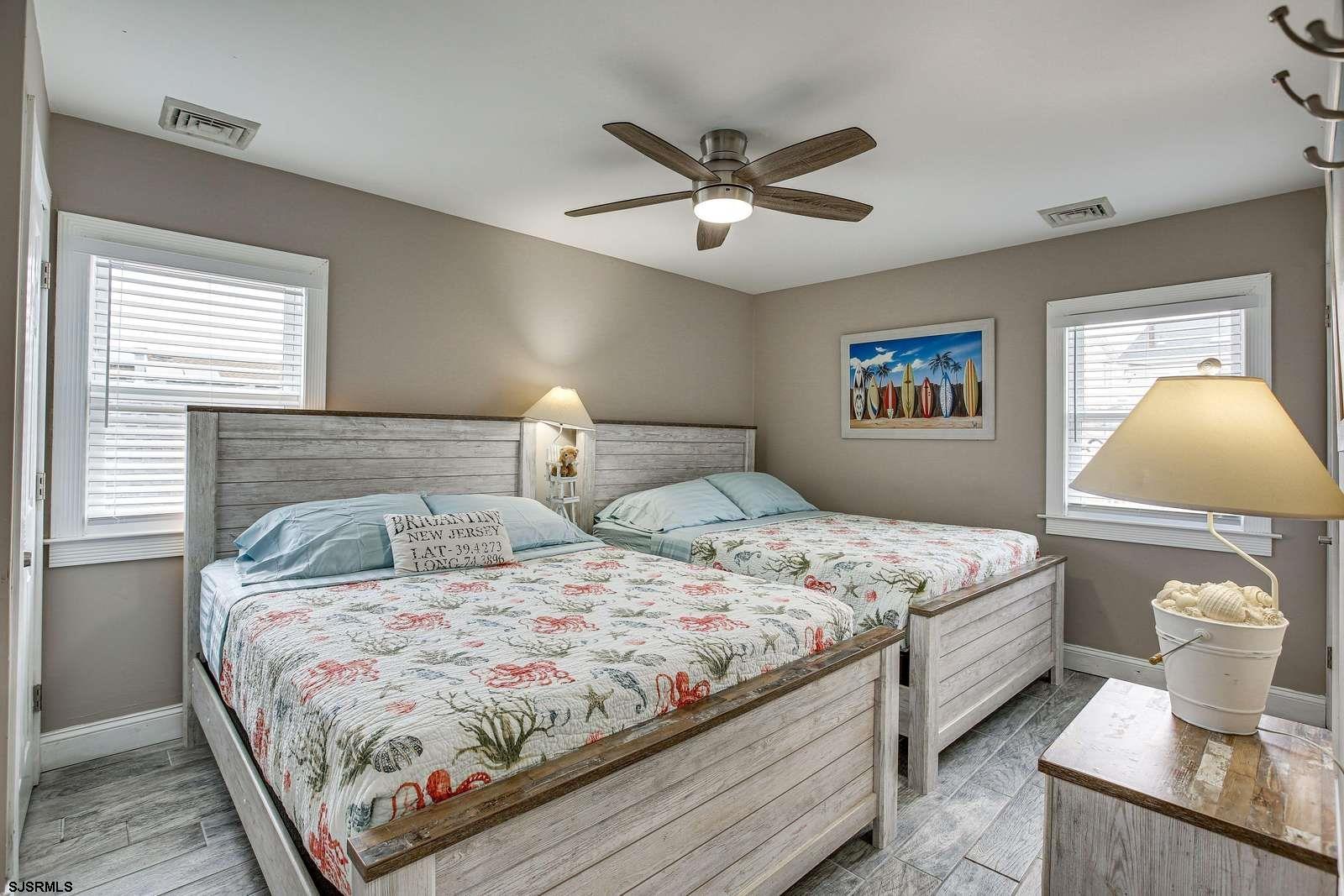 210 34th Street South, Unit 2 Brigantine, NJ 08203 - Photo 19 of 32 a bedroom with double bed and a lamp