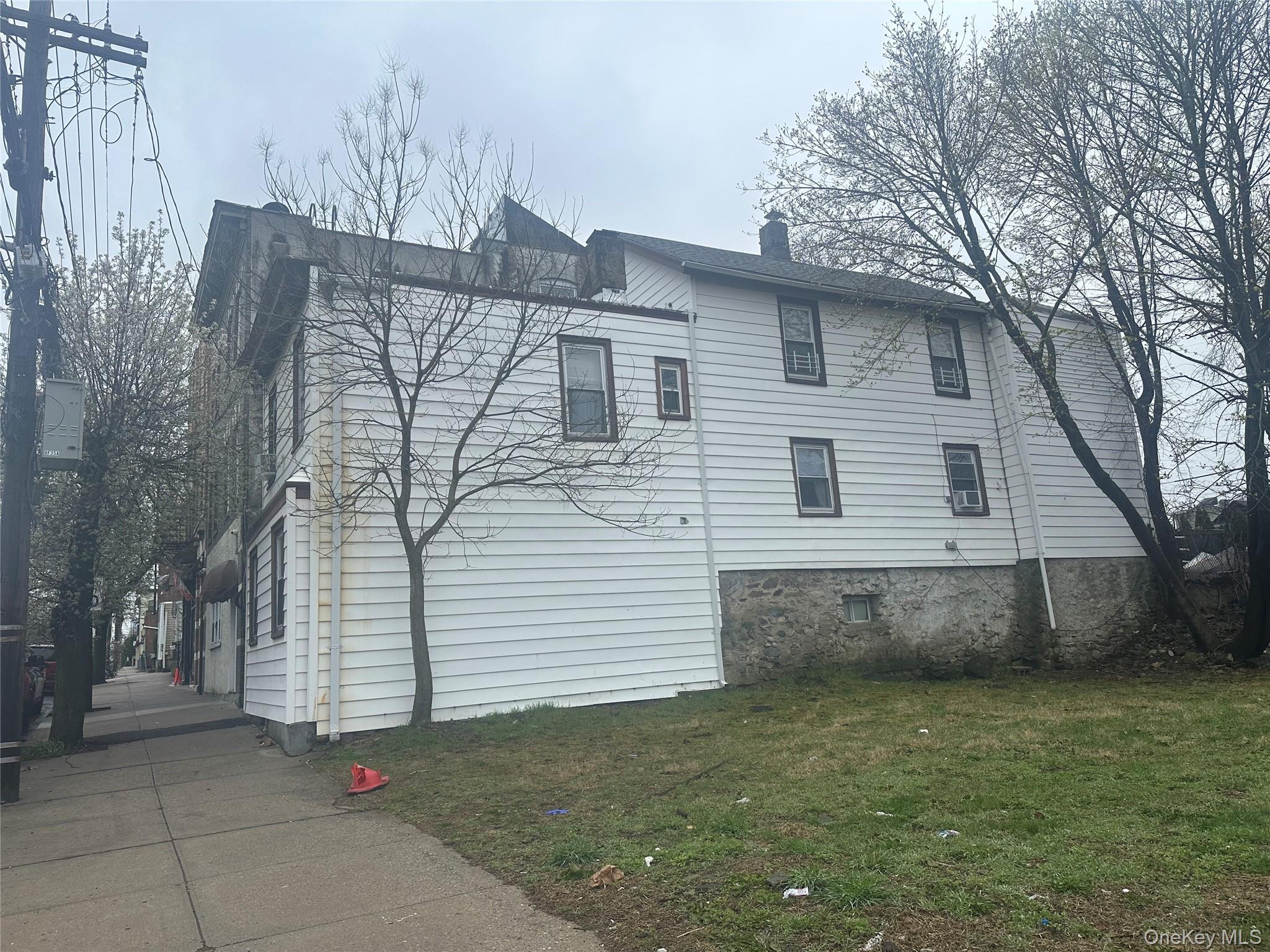 21 Drake Avenue New Rochelle, NY 10805 - Photo 2 of 18 a view of a white house with a small yard and large tree