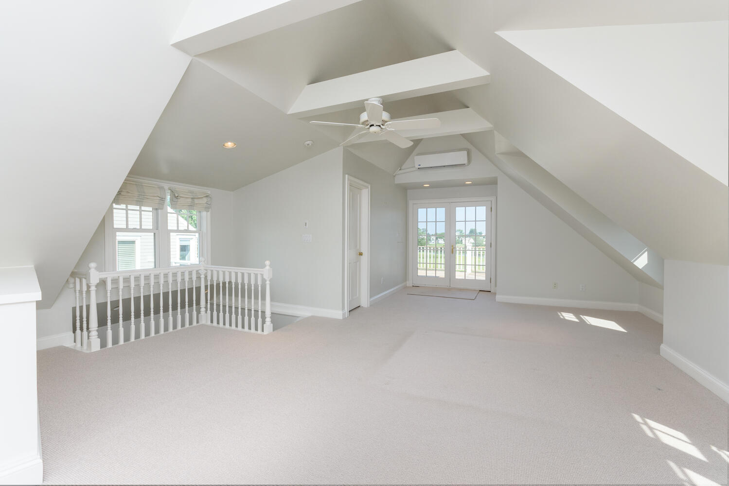 73 Roton Avenue Rowayton, CT 06853 - Photo 19 of 31 en empty room with windows and ceiling fan
