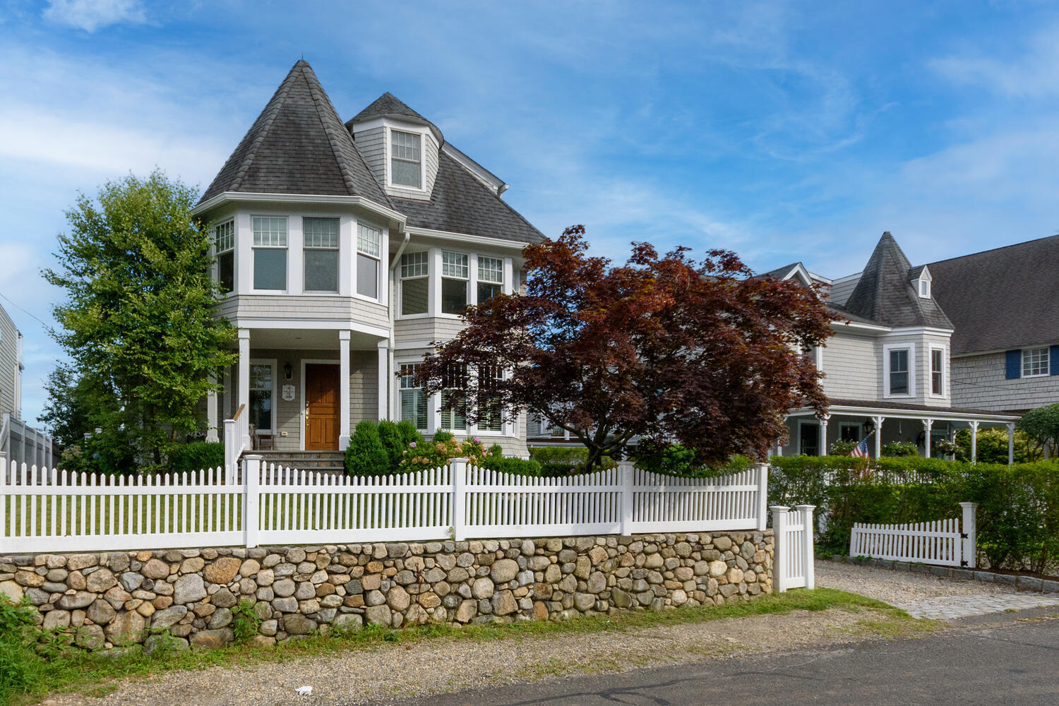 73 Roton Avenue Rowayton, CT 06853 - Photo 2 of 31 a front view of a house with a garden