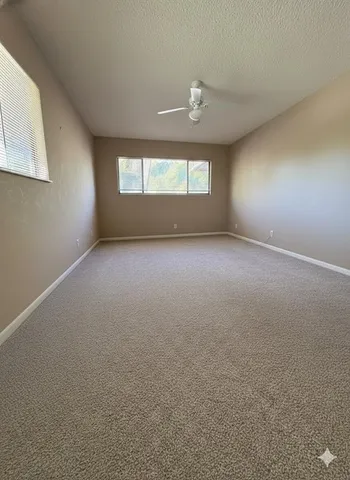 an empty room with a window and doors