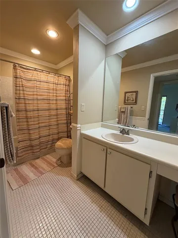 a bathroom with a double vanity sink toilet and shower
