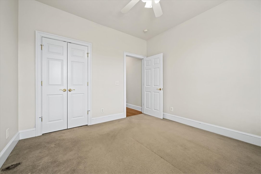 38 Angus Run Seneca, SC 29672 - Photo 24 of 46 A well-lit bedroom features plush carpeting and convenient closet doors.