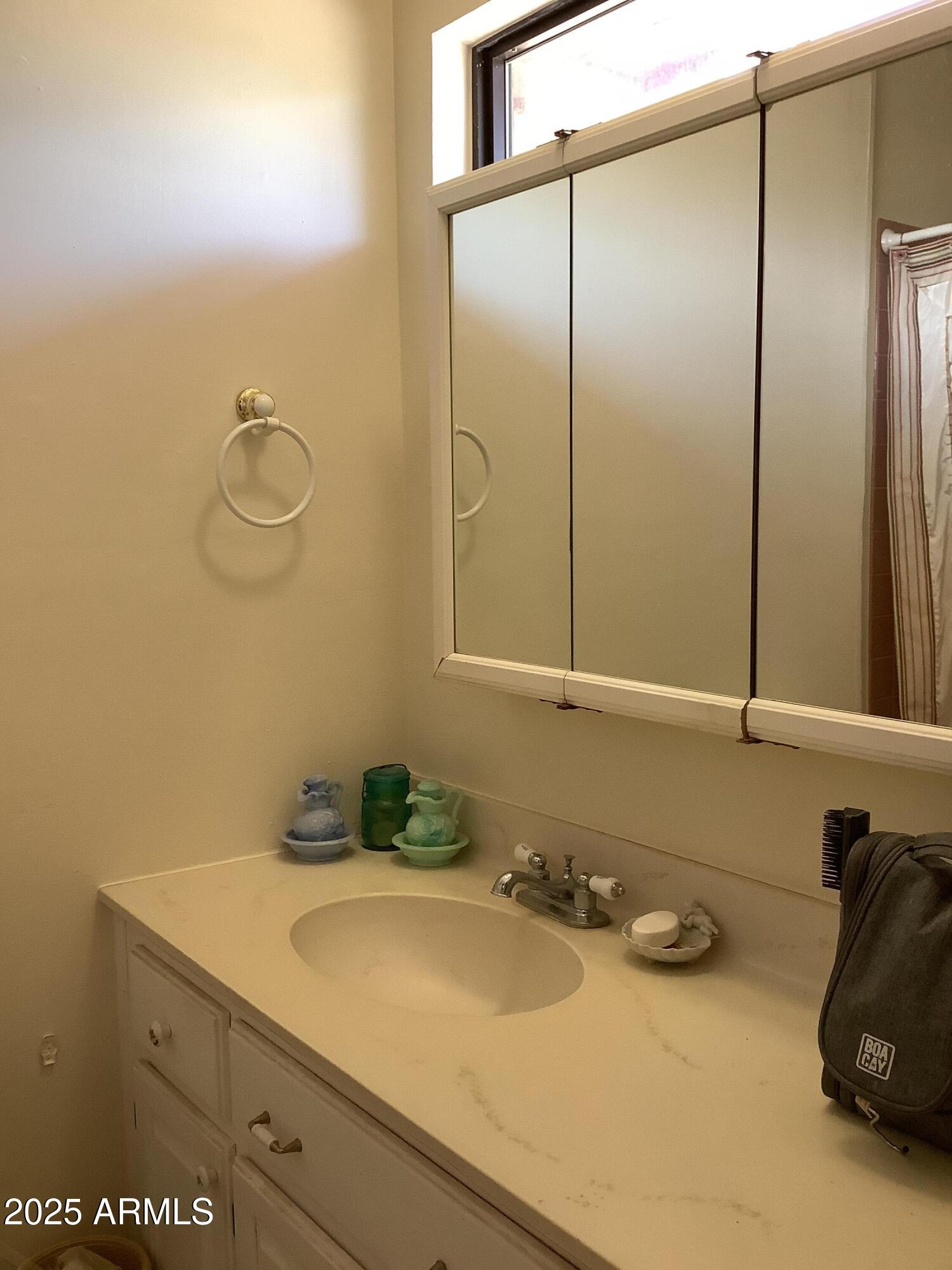 28 Cochise Way Cochise, AZ 85606 - Photo 24 of 51 a bathroom with a sink and a mirror