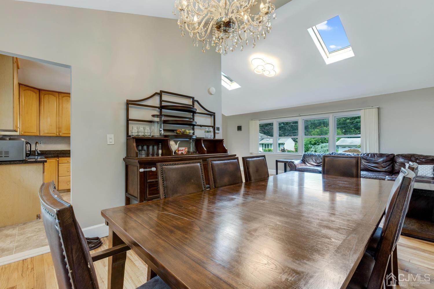 7 Colburn Road East Brunswick, NJ 08816 - Photo 12 of 25 a dining room with furniture a chandelier and wooden floor